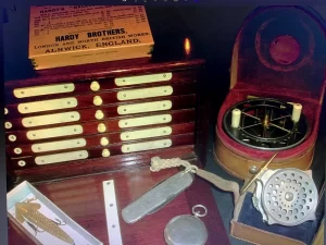 Hardy Unique Fly cabinet, with Hardy Bougle fly reel Hardy Anglers knife, Allcock Wire devon circa 1897 bait and Allcock Aerial reel.